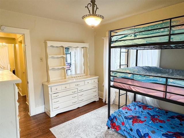 bedroom with dark hardwood / wood-style flooring