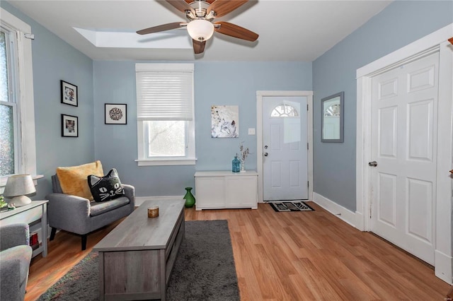 foyer entrance with ceiling fan and light hardwood / wood-style floors