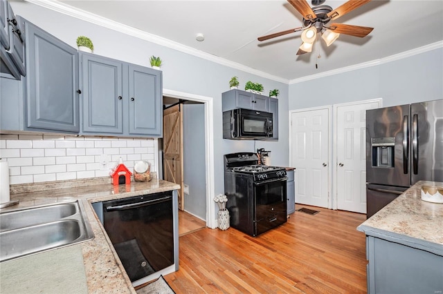 kitchen with ceiling fan, ornamental molding, backsplash, black appliances, and light wood-type flooring