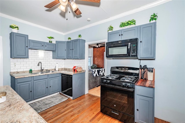 kitchen featuring black appliances, crown molding, sink, decorative backsplash, and light hardwood / wood-style floors