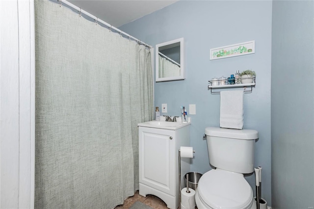 bathroom with tile patterned flooring, vanity, and toilet