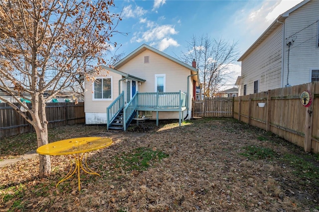 back of property featuring a wooden deck