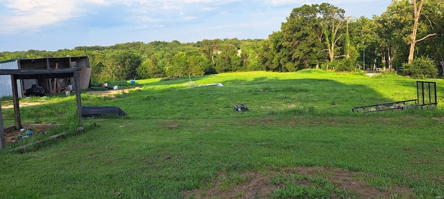 view of yard featuring a forest view