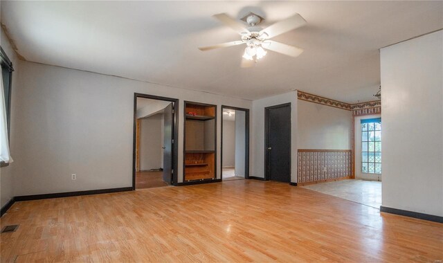 spare room with hardwood / wood-style floors and ceiling fan