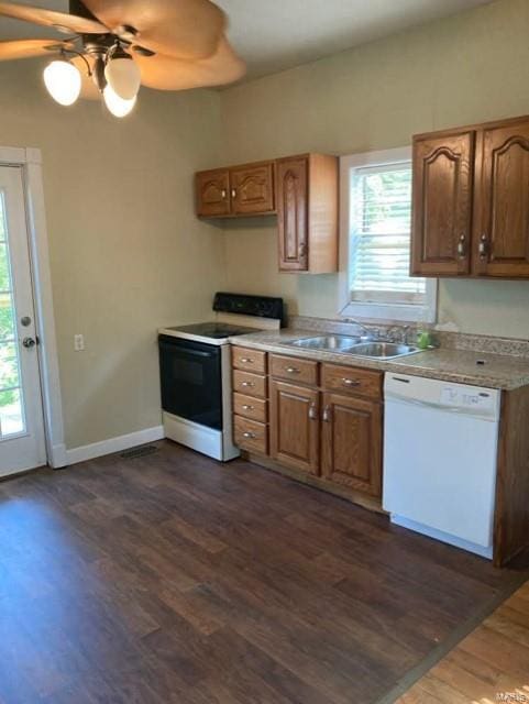 kitchen featuring a wealth of natural light, white appliances, ceiling fan, and sink