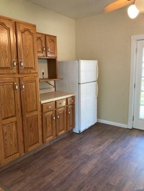 kitchen with white fridge, ceiling fan, and dark wood-type flooring