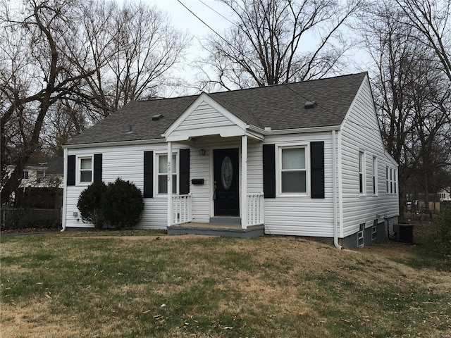 view of front of home with central AC and a front yard