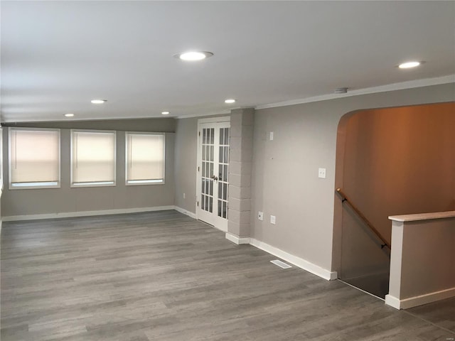 spare room featuring dark hardwood / wood-style flooring and ornamental molding