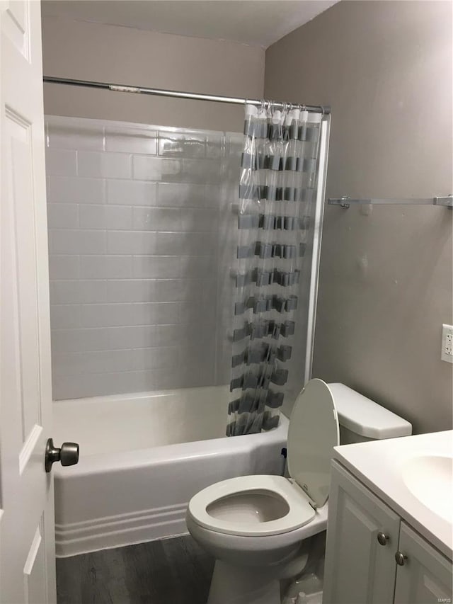 full bathroom with vanity, wood-type flooring, shower / tub combo, and toilet