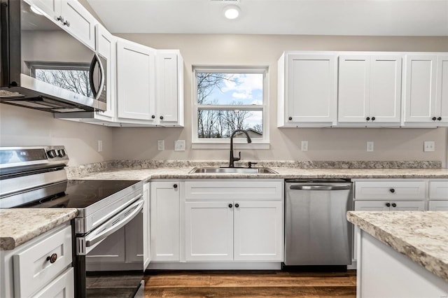 kitchen featuring light stone countertops, sink, white cabinets, and appliances with stainless steel finishes