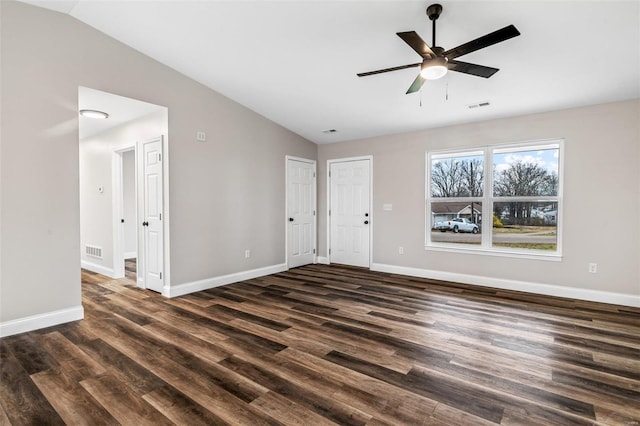 spare room with ceiling fan, dark wood-type flooring, and vaulted ceiling