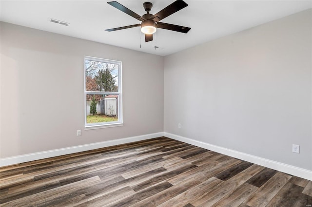 unfurnished room with ceiling fan and dark hardwood / wood-style flooring