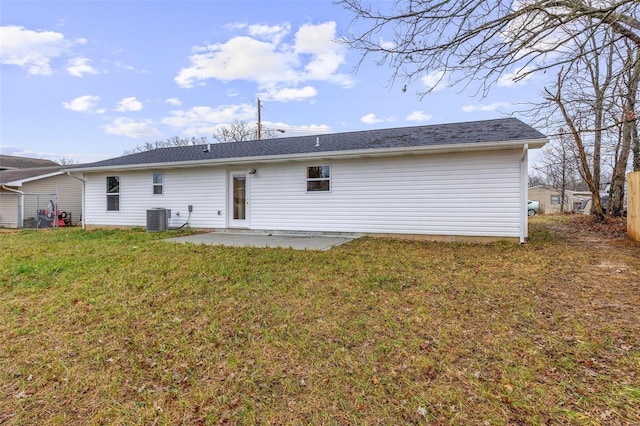 back of property featuring central air condition unit, a lawn, and a patio