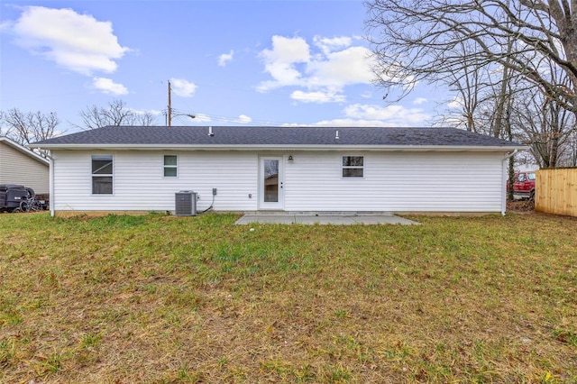 back of house with central AC unit, a yard, and a patio