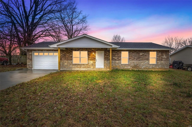 ranch-style home with a garage and a lawn