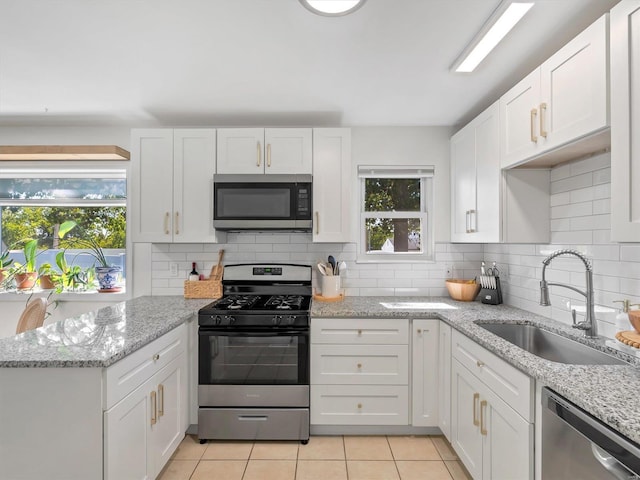 kitchen featuring sink, white cabinets, and appliances with stainless steel finishes