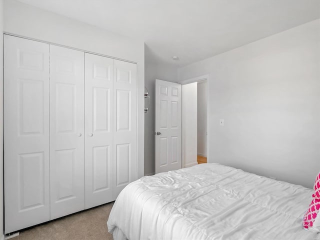 carpeted bedroom featuring a closet