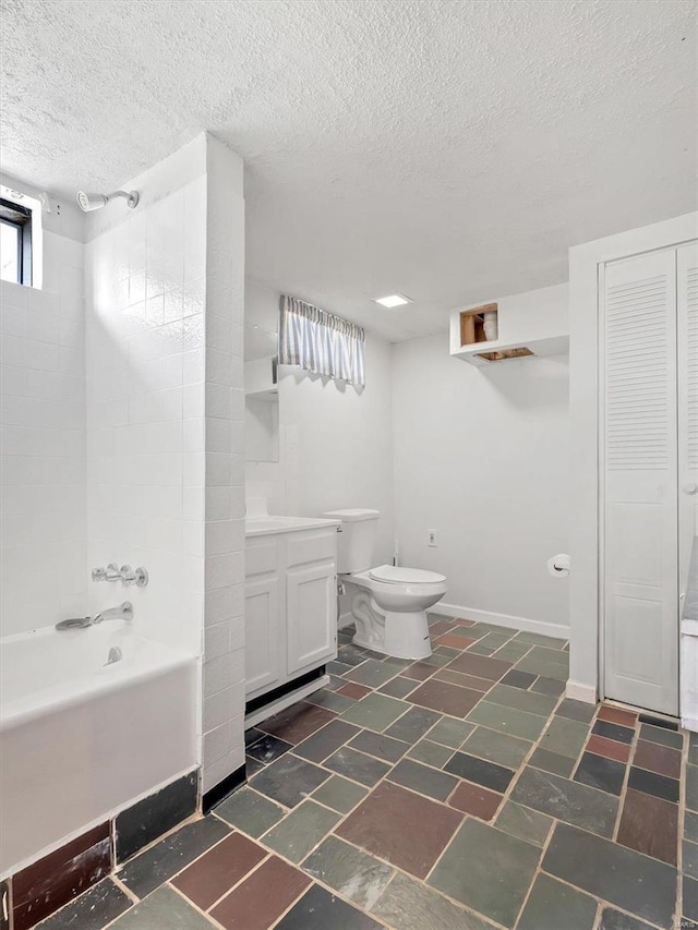 full bathroom featuring a textured ceiling, vanity, toilet, and shower / washtub combination