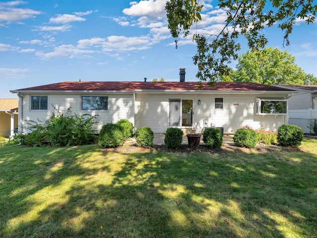 rear view of house with a yard