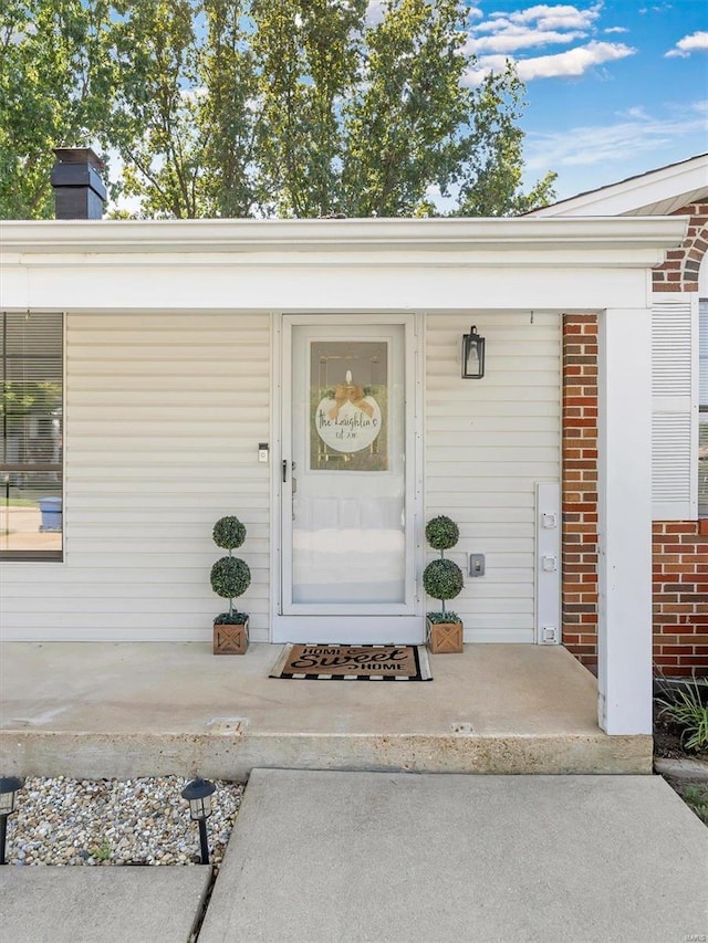 doorway to property with a porch