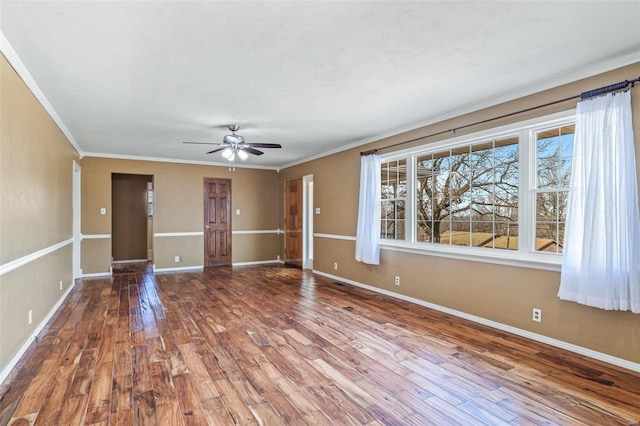 empty room featuring wood-type flooring, ornamental molding, and ceiling fan