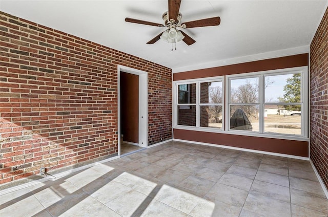 unfurnished sunroom with ceiling fan