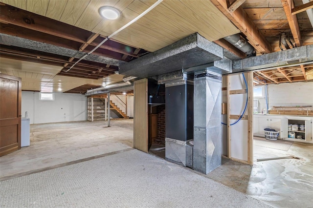 basement with washer / dryer and heating unit