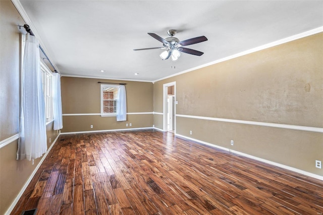 empty room with ornamental molding, dark hardwood / wood-style floors, and ceiling fan