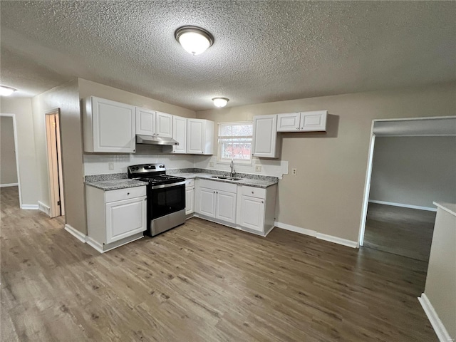 kitchen featuring white cabinetry, electric range, and light hardwood / wood-style floors