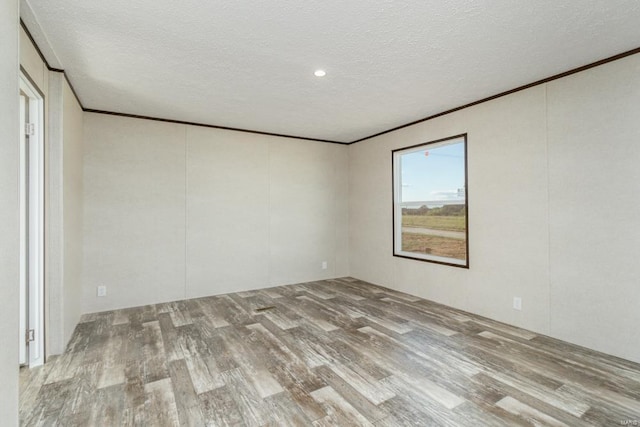 unfurnished room featuring a textured ceiling and hardwood / wood-style flooring