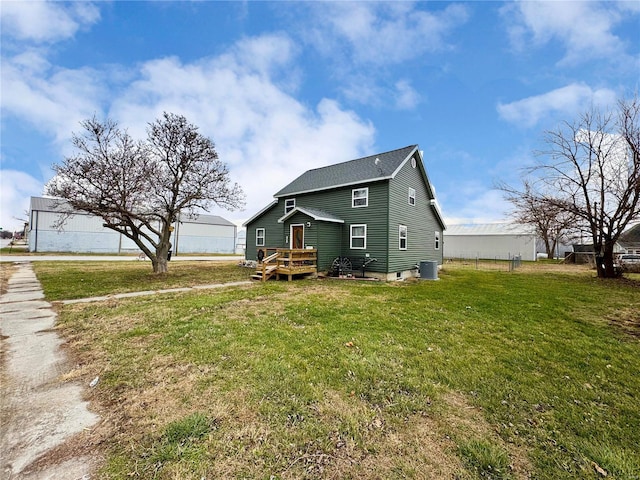 rear view of house featuring a yard, a deck, and central AC