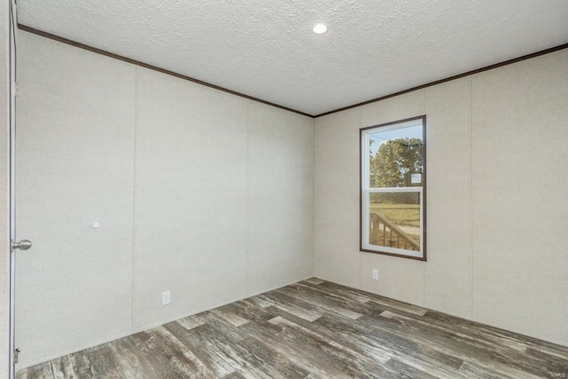 unfurnished room featuring hardwood / wood-style floors and a textured ceiling