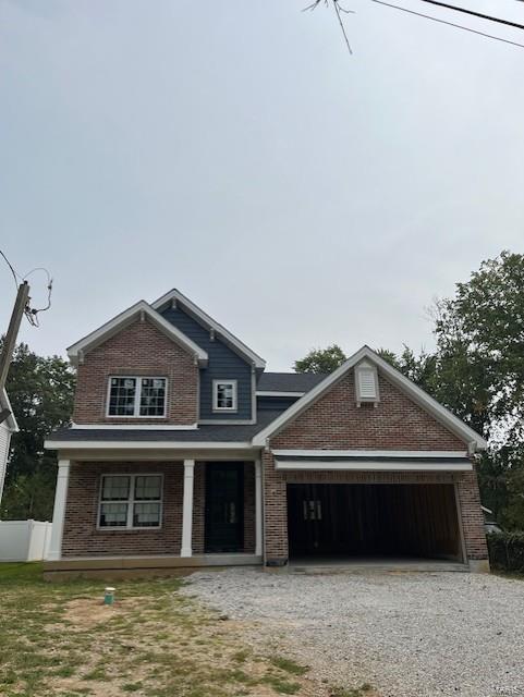 view of front of home featuring covered porch and a garage