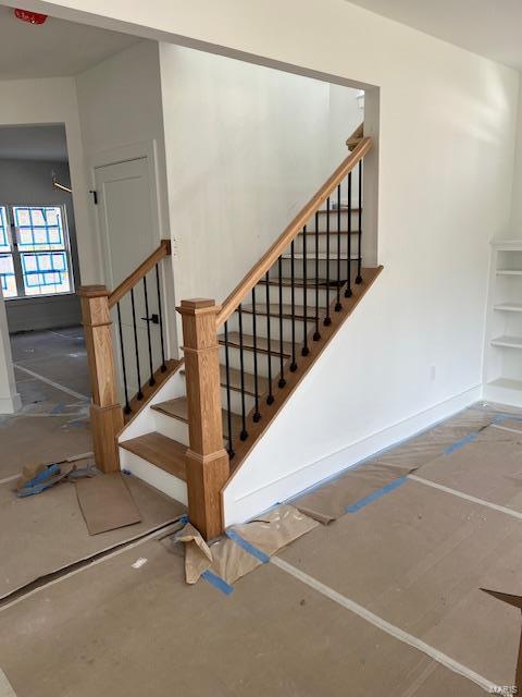 stairway featuring baseboards