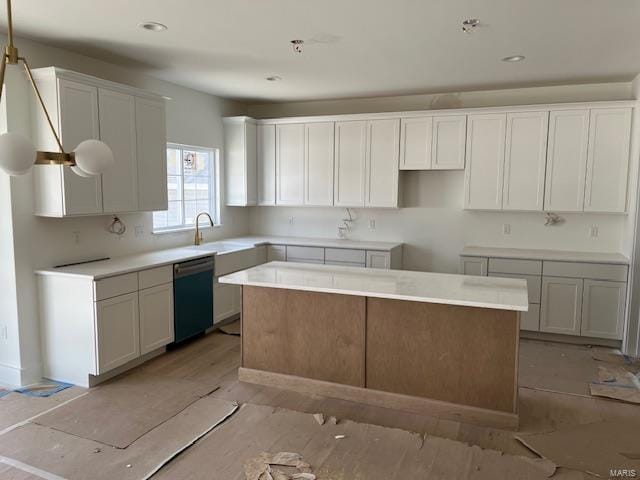 kitchen with white cabinetry, a kitchen island, a sink, light wood-style floors, and dishwasher