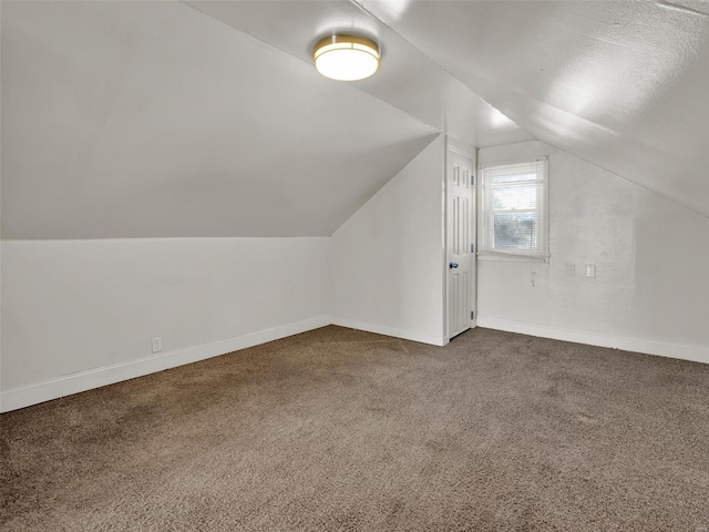 bonus room featuring carpet floors and vaulted ceiling