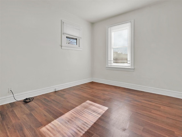 spare room featuring dark wood-type flooring