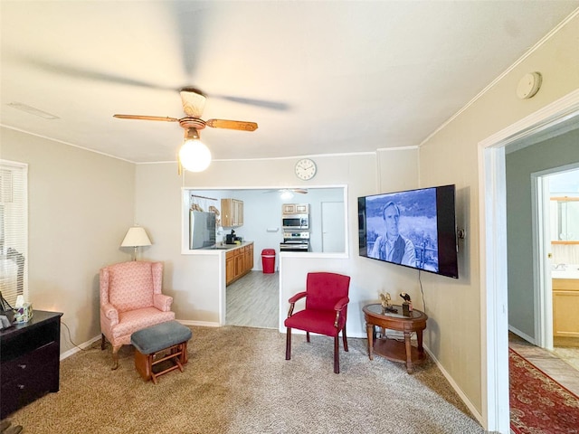 living area with ceiling fan and light colored carpet