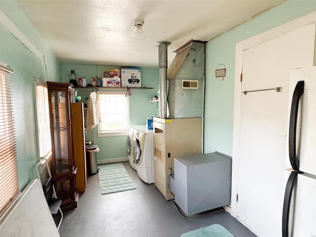 clothes washing area featuring washer and dryer