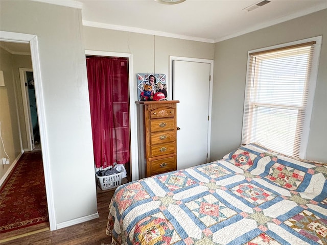 bedroom with dark hardwood / wood-style flooring, a closet, and crown molding