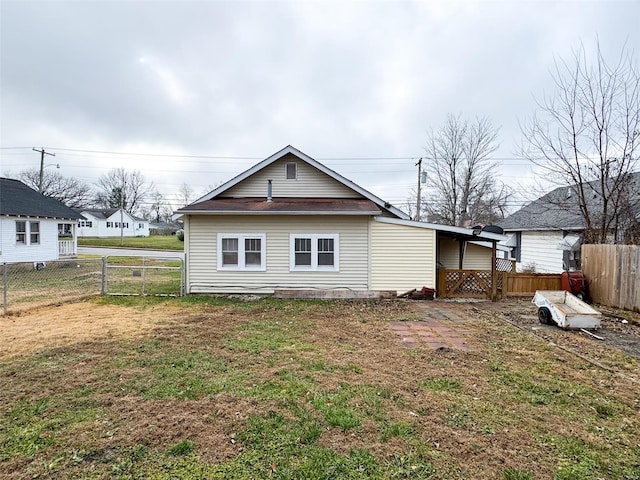 rear view of property featuring a yard