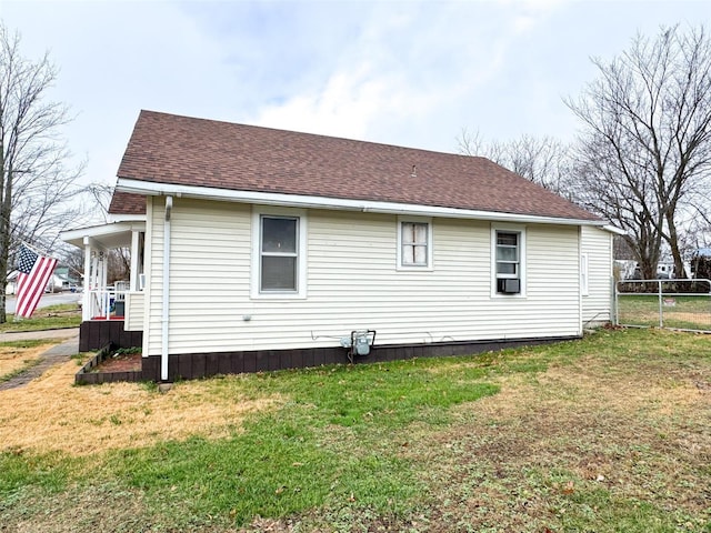 rear view of property with a yard