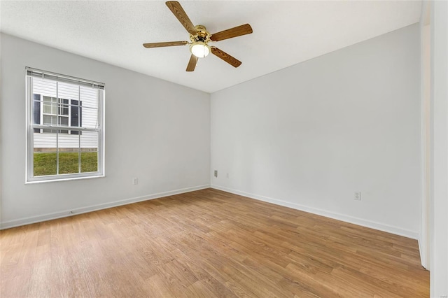 spare room featuring light hardwood / wood-style floors and ceiling fan