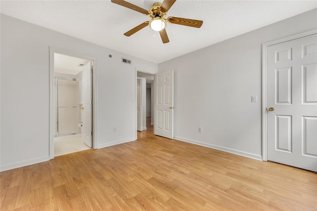 unfurnished bedroom featuring connected bathroom, light hardwood / wood-style flooring, and ceiling fan