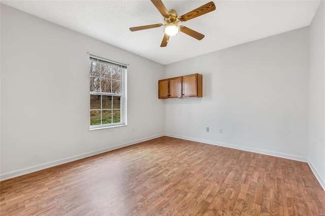 unfurnished room featuring ceiling fan and light hardwood / wood-style floors