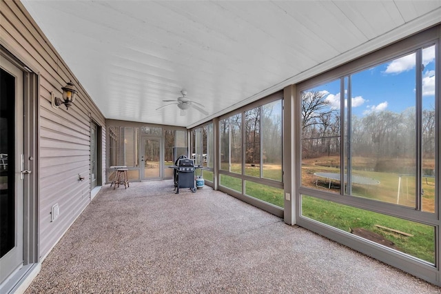 unfurnished sunroom featuring plenty of natural light and a ceiling fan