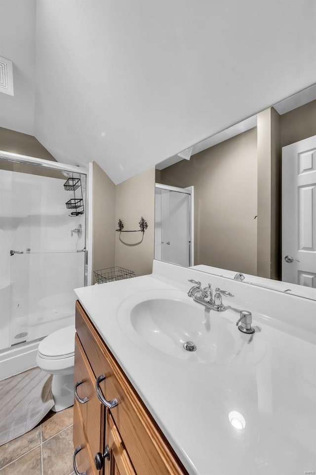 bathroom with a stall shower, visible vents, toilet, lofted ceiling, and vanity