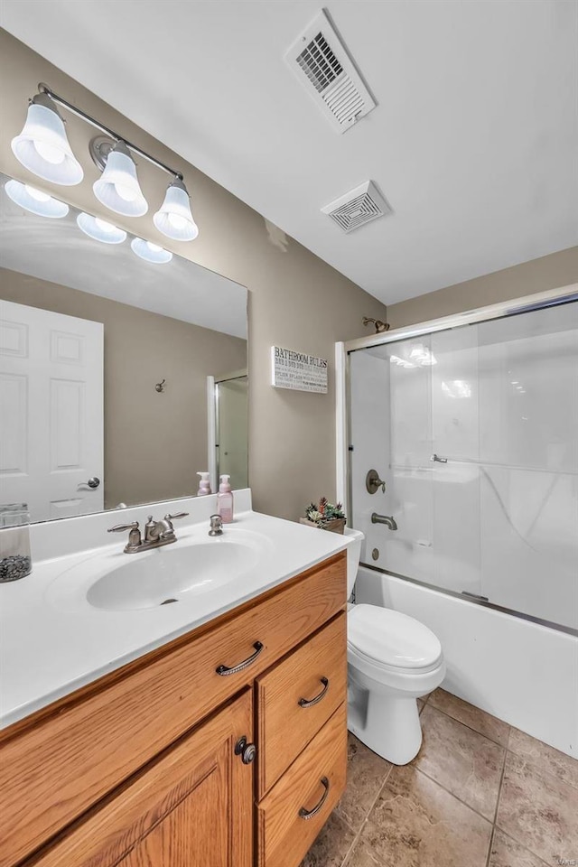 full bath with visible vents, vanity, toilet, and bath / shower combo with glass door