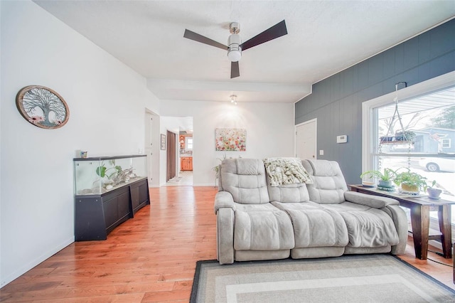 living room featuring a textured ceiling, ceiling fan, and light hardwood / wood-style flooring