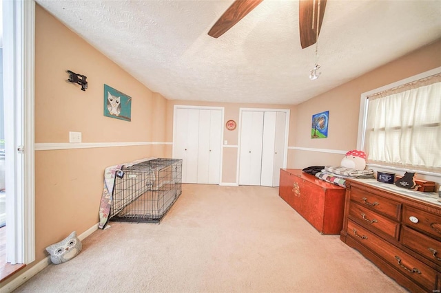 miscellaneous room with light carpet, a textured ceiling, and ceiling fan